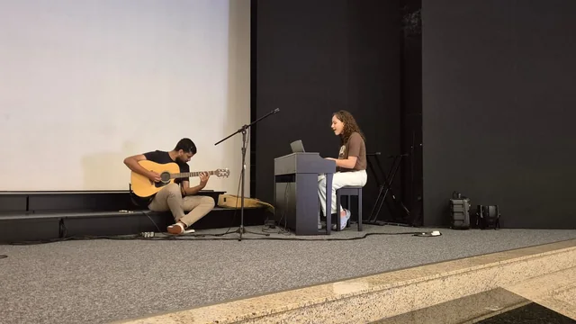 Participantes tocando violão e teclado durante o encontro